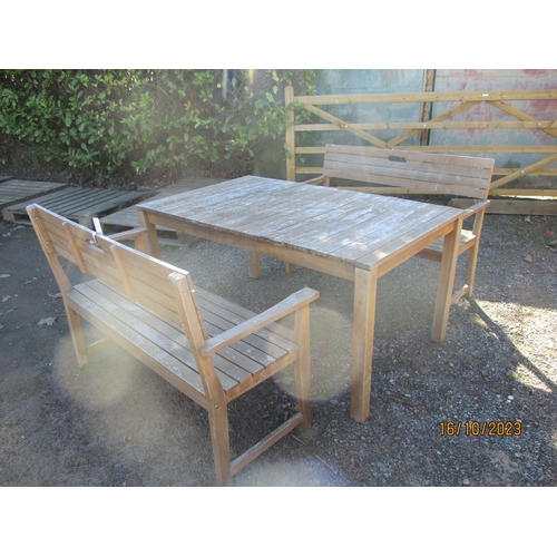 45 - A rectangular teak garden table together with two matching benches