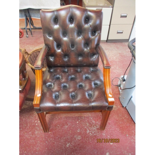 253 - A mahogany framed open library armchair upholstered in brown button back leather