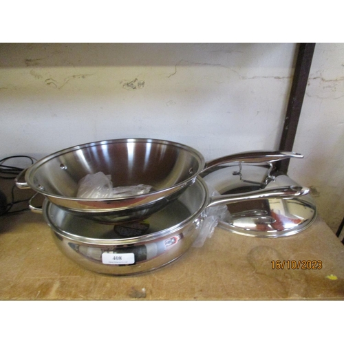 408 - A stainless steel wok and saucepan - new