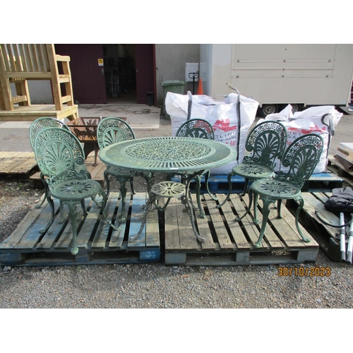 73 - A pierced aluminium circular garden table together with six matching chairs