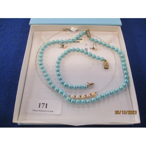 171 - A silver and pearl necklace and earring set together with a string of blue pearls and matching brace... 