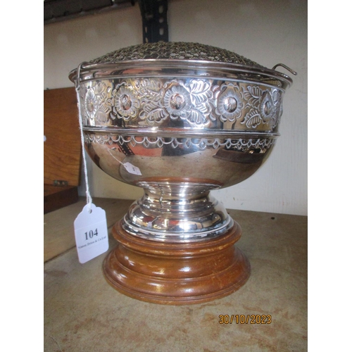 104 - A silver plated rose bowl mounted upon a mahogany stand