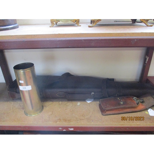 121 - A leg of mutton gun case, a leather cased cleaning kit and a brass ammunition shell case