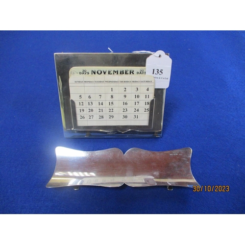 135 - A vintage silver framed desk calendar together with a silver pen tray