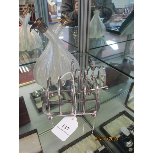 137 - A glass vinaigrette with silver mounts together with two silver toast racks