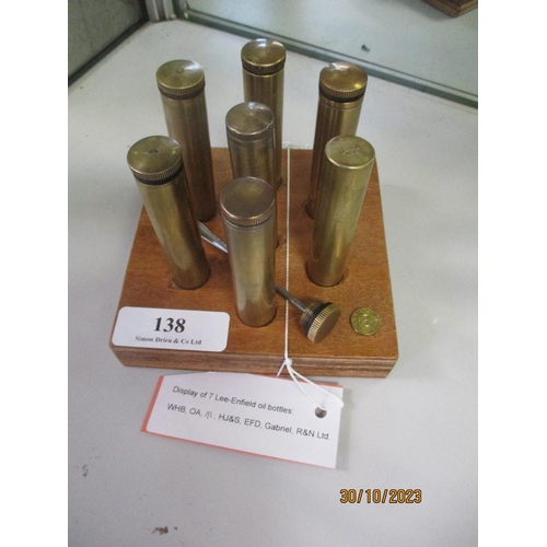 138 - A display of seven vintage Lee-Enfield oil bottles