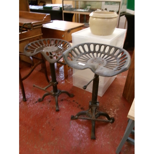 236 - Two cast iron adjustable tractor seat breakfast stools