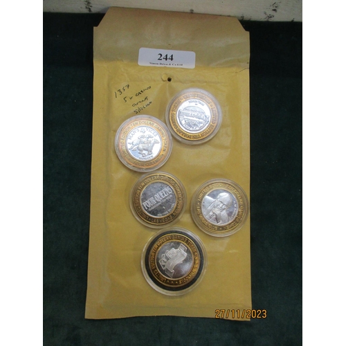 244 - Five solid silver casino coins