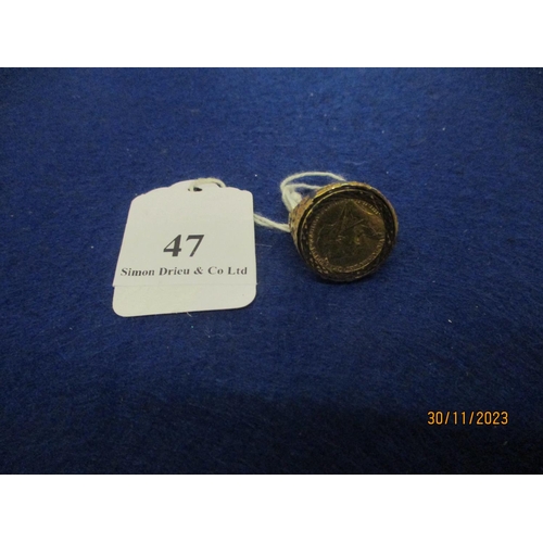 47 - A gold ring mounted with a 22nd carat gold half sovereign size U