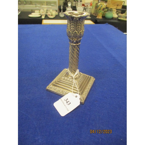 343 - A silver candle stick holder the spiral column topped by Acanthus leaves