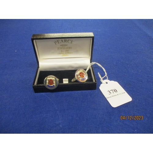 370 - A pair of silver cufflinks with Parish of St. Peter crest