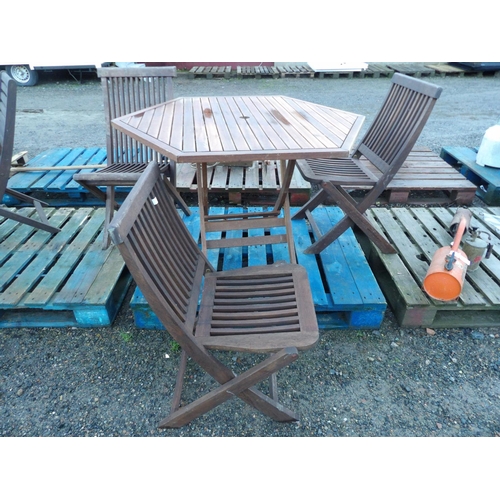 57 - A teak hexagonal garden table together with three teak chairs