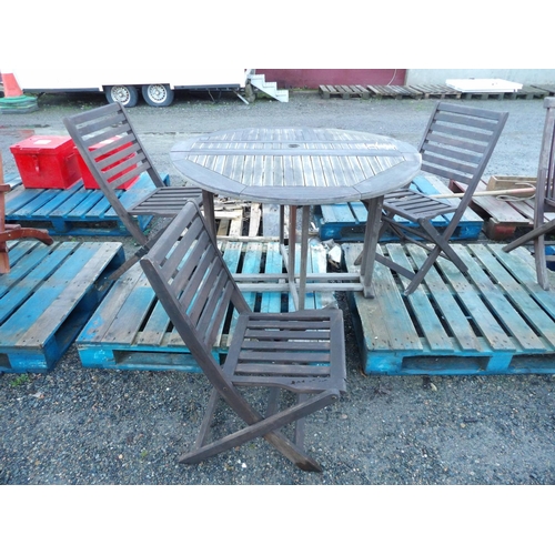 58 - A teak twin flap gate leg garden table together with three matching chairs