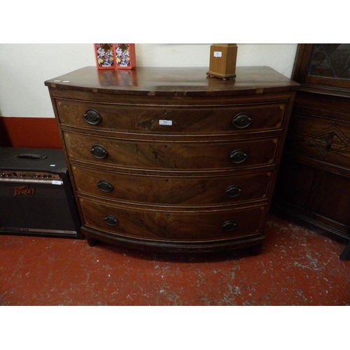 221 - A George III mahogany bow fronted chest of four long graduated drawers