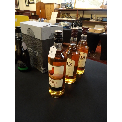 284 - Two 1L bottles of Bell's Blended Scotch Whisky together with a 1L bottle of The Famous Grouse Blende... 