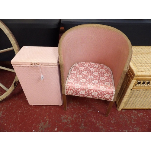 328 - An early twentieth century Lloyd Loom armchair and similar linen basket both finished in pink