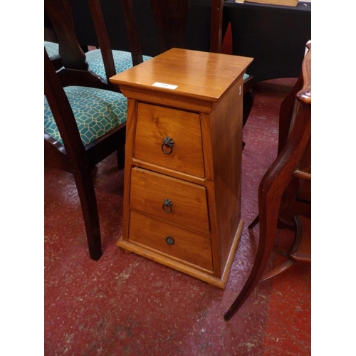 339 - A hard wood chest of three graduated drawers of triangulated form