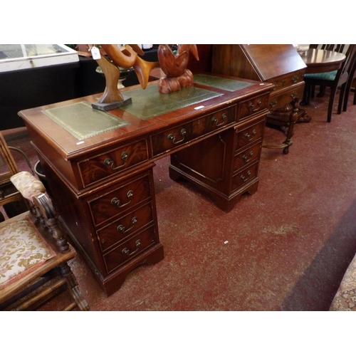 342 - A mahogany twin pedestal desk the top inlaid with green gilded and tooled leather