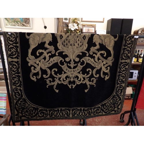 350 - A floor rug on black ground with Acanthus border and heraldic crest 