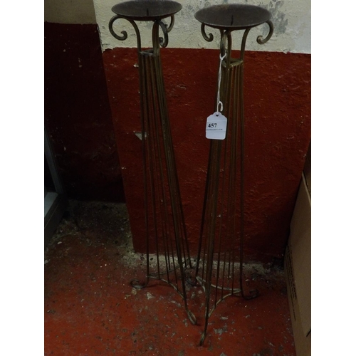 457 - A pair of tall wrought metal candle stands