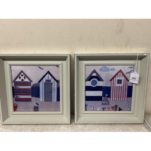 302 - A pair of contemporary framed fabric prints depicting beach huts