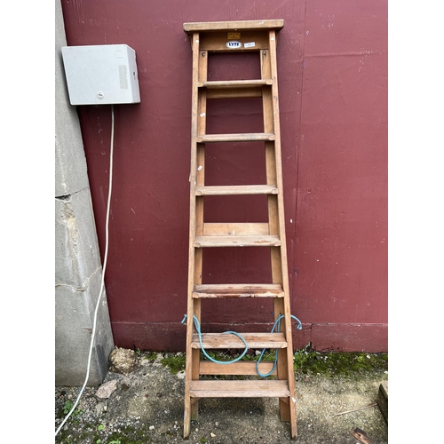 31 - A vintage eight tread stepladder by Messrs. Lyte