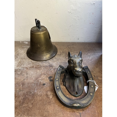 67 - A bronze bell together with a brass door knocker modelled in the form of a horses head and horseshoe