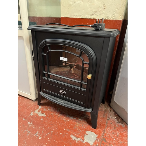 79 - A Dimplex living flame electric fire modelled in the form of a wood burning stove, remove control wi... 