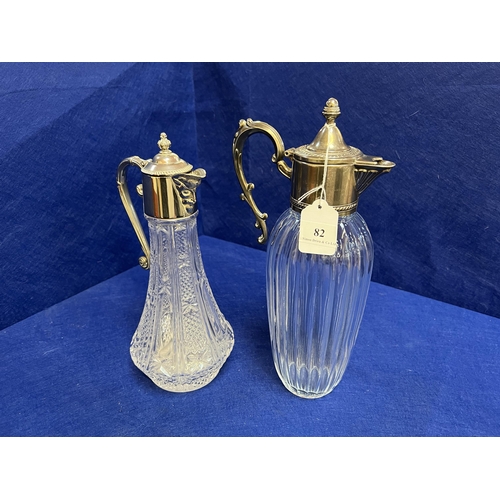 82 - Two glass claret jugs each with silver plated mounts