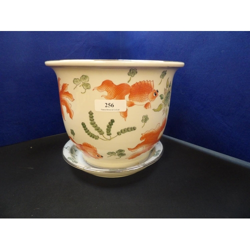 256 - An oriental cache pot and saucer decorated with koi carp