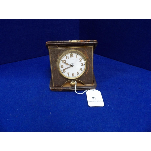 97 - A vintage leather cased eight day travelling clock by Finnigans