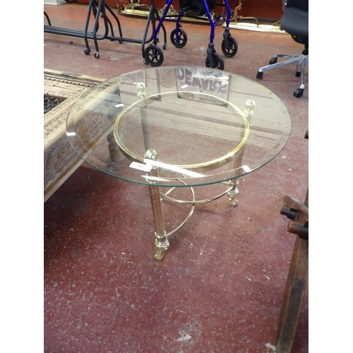 180 - A circular bevelled glass lamp table with gilded base