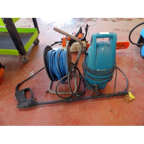 63 - A Makita pressure washer together with a cable reel