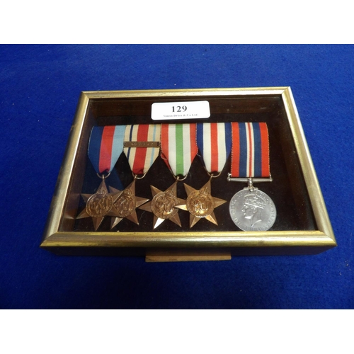 129 - A bar of five World War II military medals contained within a table frame