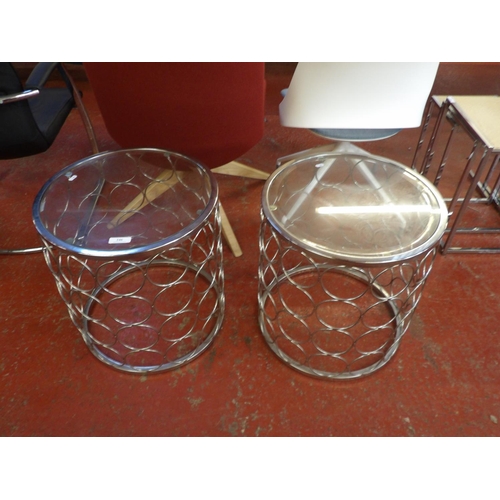 246 - A pair of contemporary chrome and glass occasional tables of circular form