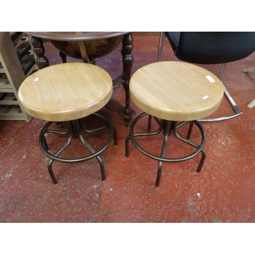 247 - A pair of adjustable oak seated stools modelled in the industrial style