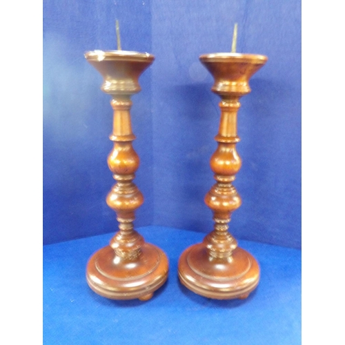 257 - A pair of wooden candle stick holders modelled in the vintage style