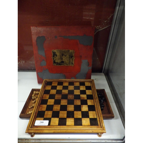 299 - A hard wood chess board and pieces complete with storage box modelled in the oriental style