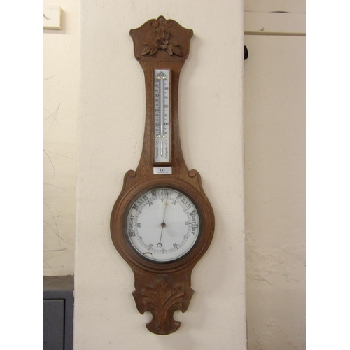 143 - A vintage oak cased aneroid barometer