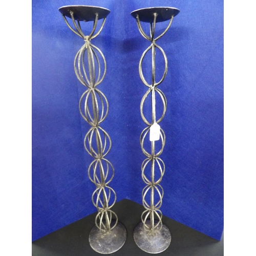 275 - A pair of tall wrought metal candle stands