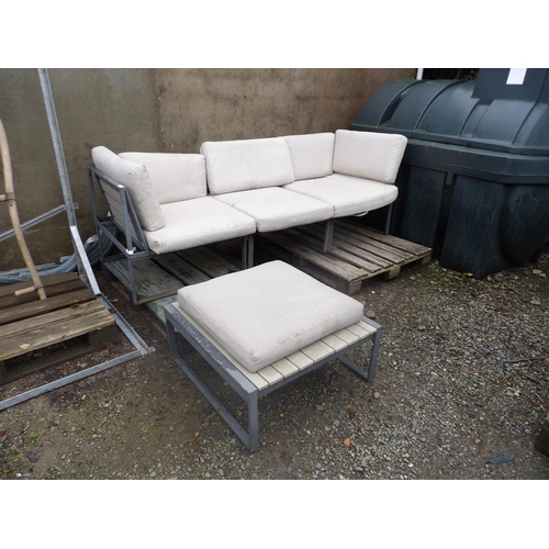 43 - A metallic framed garden couch with matching stool and cushions