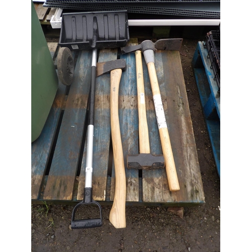 62 - A snow shovel together with a grubbing axe, a sledge hammer and a felling axe