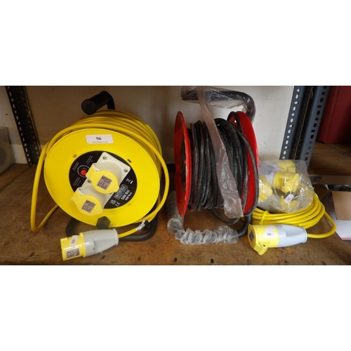 96 - A 110 volt cable reel, a 240 volt cable reel and a 110 volt extension lead and junction box - all ne... 