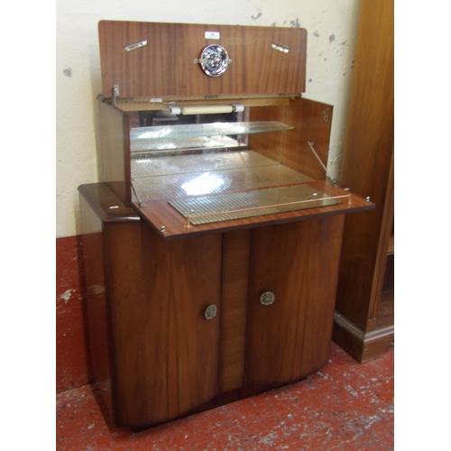 198 - A retro 1950's walnut cocktail cabinet with mechanical opening