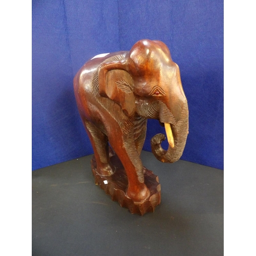 219 - A hard wood carving of a bull elephant