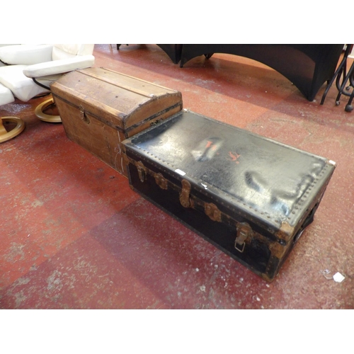 244 - A vintage dome top travelling trunk together with one other