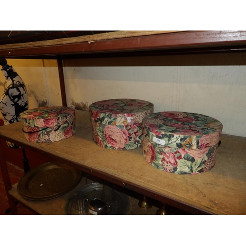 304 - A graduated set of three circular upholstered boxes