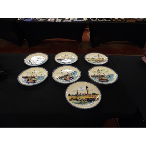 369 - A set of seven French faience plates each depicting sailing boats