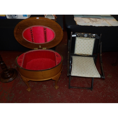 301 - A vintage ebonised folding campaign chair together with a mahogany work box of oval form