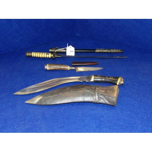 319 - A kukri together with two daggers